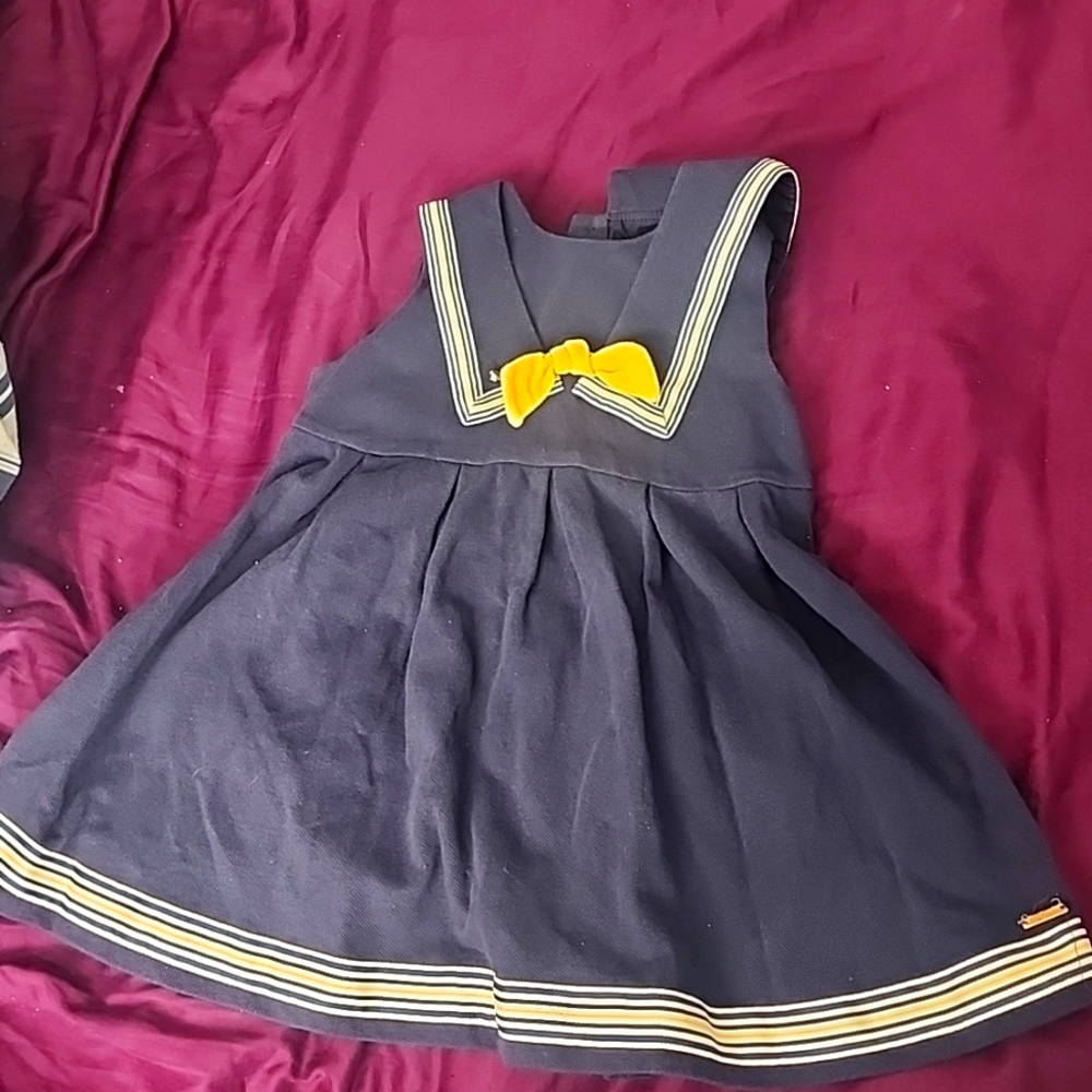 Navy blue sleeveless dress with yellow and blue trim